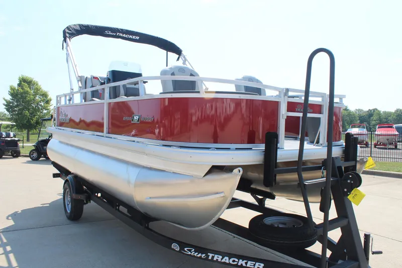 Slide: The Image of 2026 Sun Tracker Bass Buggy 18 DLX pontoon boat on trailer, red and silver design. - 4
