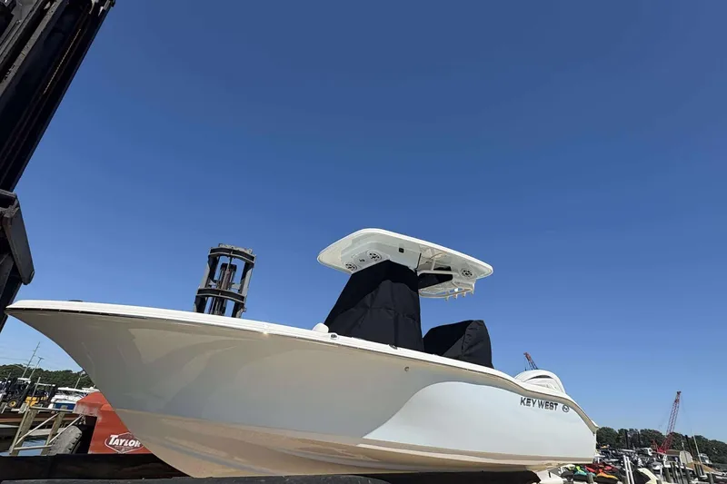 The Image of 2026 Key West 219 FS boat on forklift under clear blue sky. - 0