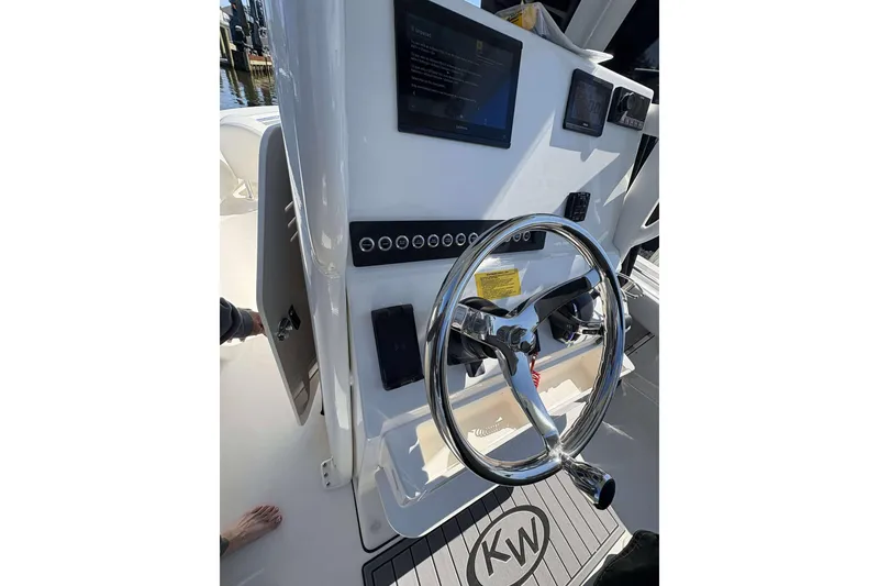 Slide: The Image of Steering console of 2026 Key West 219 FS boat with modern controls and displays. - 10