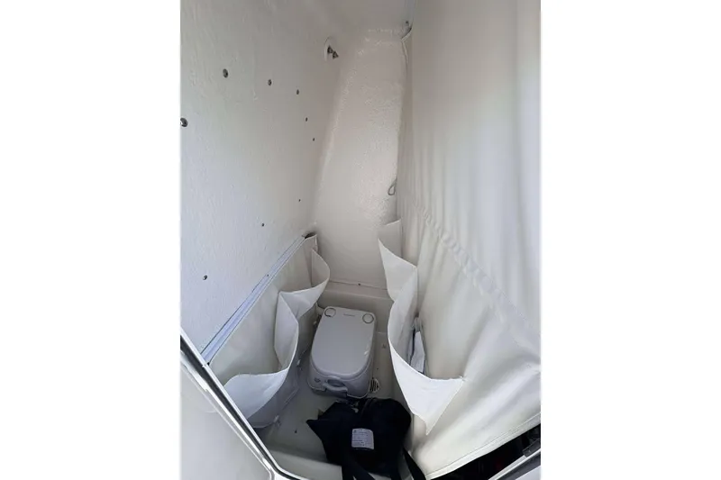 Slide: The Image of Interior of 2026 Key West 219 FS boat with compact marine toilet. - 12