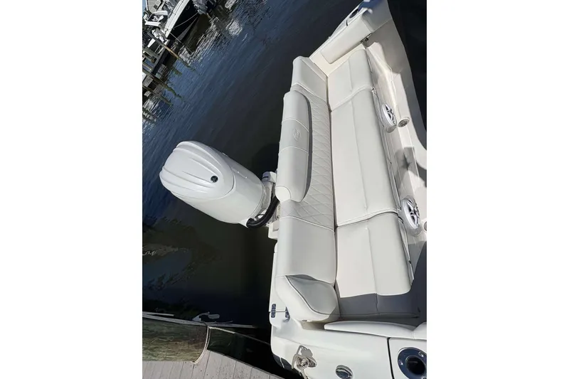 Slide: The Image of 2026 Key West 219 FS boat with outboard motor and cushioned seating. - 16