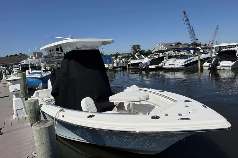 Slide: The Image of 2026 Key West 219 FS boat docked at marina, surrounded by other vessels. - 4