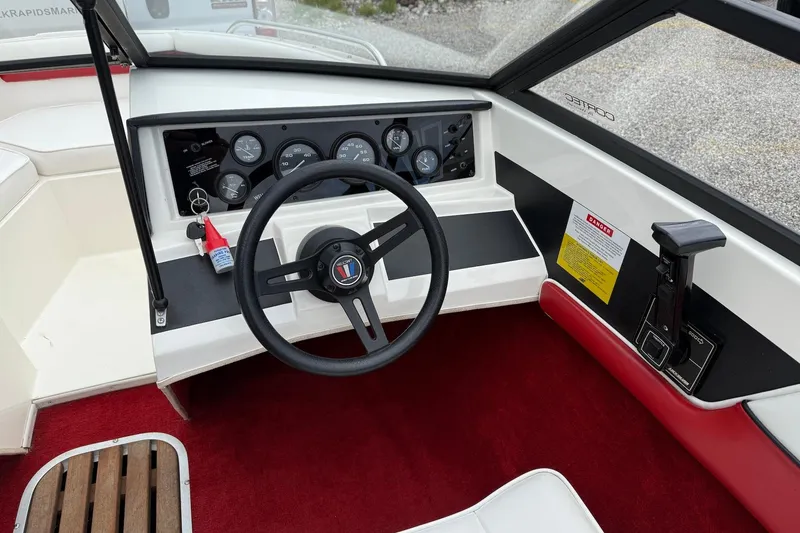 Slide: The Image of Interior of a 1991 Wellcraft 170 Sport boat, featuring steering wheel and dashboard controls. - 10