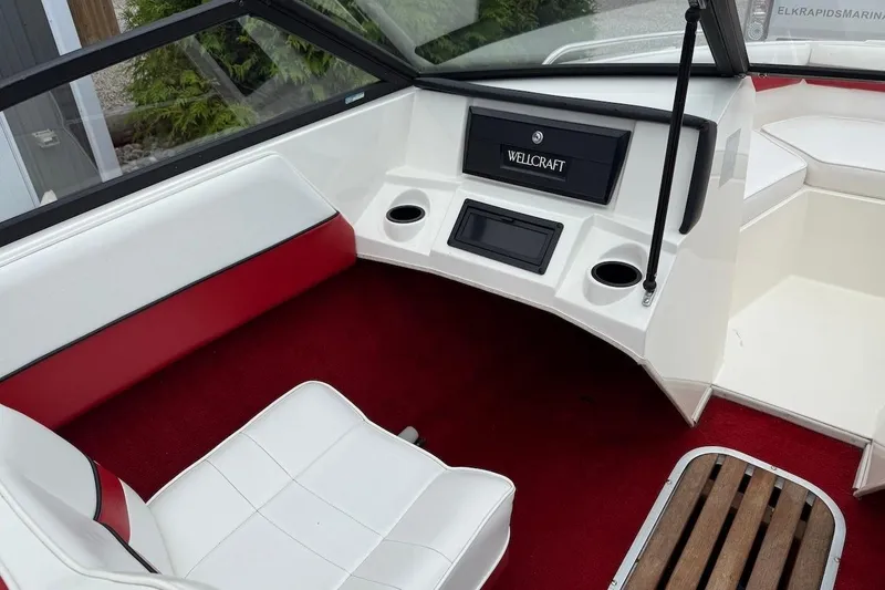Slide: The Image of Interior of a 1991 Wellcraft 170 Sport boat with red and white seating. - 11