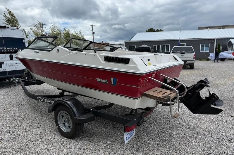 Slide: The Image of 1991 Wellcraft 170 Sport boat on trailer, red and white design, parked outdoors. - 6