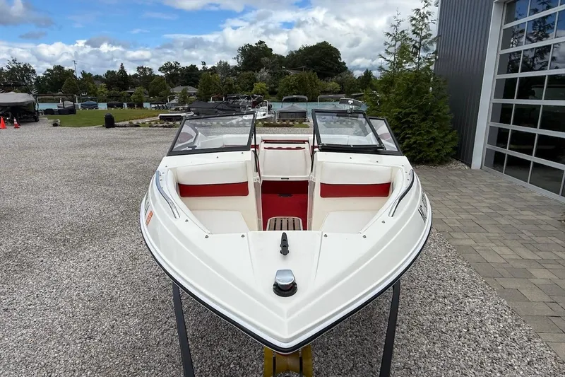 Slide: The Image of 1991 Wellcraft 170 Sport boat displayed outdoors, featuring white and red interior. - 8