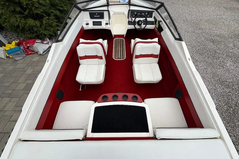 Slide: The Image of 1991 Wellcraft 170 Sport boat interior with red and white seating and dashboard. - 9