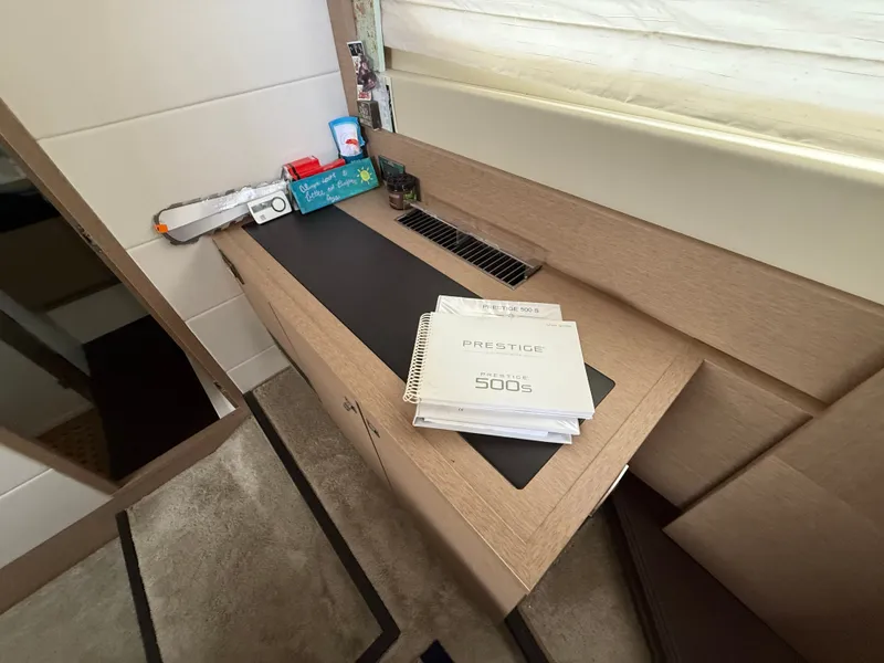 Slide: The Image of Manuals for 2018 Prestige 500 S yacht on a wooden desk. - 10