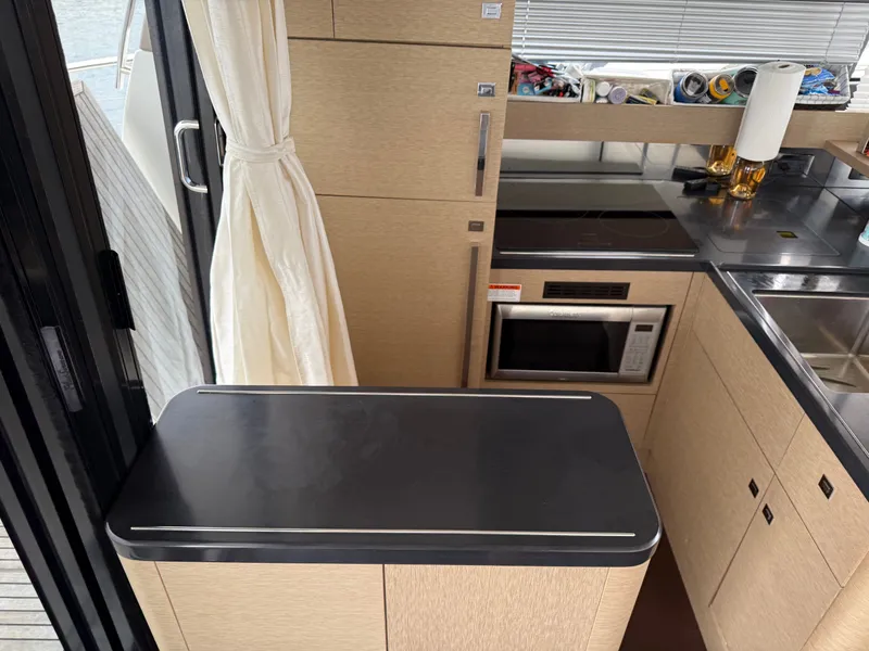 Slide: The Image of Modern kitchen interior on a 2018 Prestige 500 S yacht, featuring sleek cabinetry and appliances. - 4