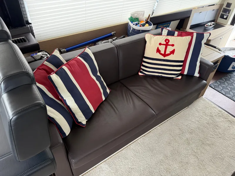 Slide: The Image of Luxurious leather sofa with nautical-themed cushions on a 2018 Prestige 500 S yacht. - 5