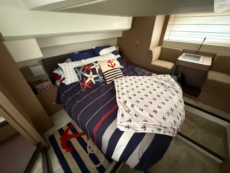 Slide: The Image of Luxurious cabin interior of 2018 Prestige 500 S yacht with nautical-themed bedding. - 8