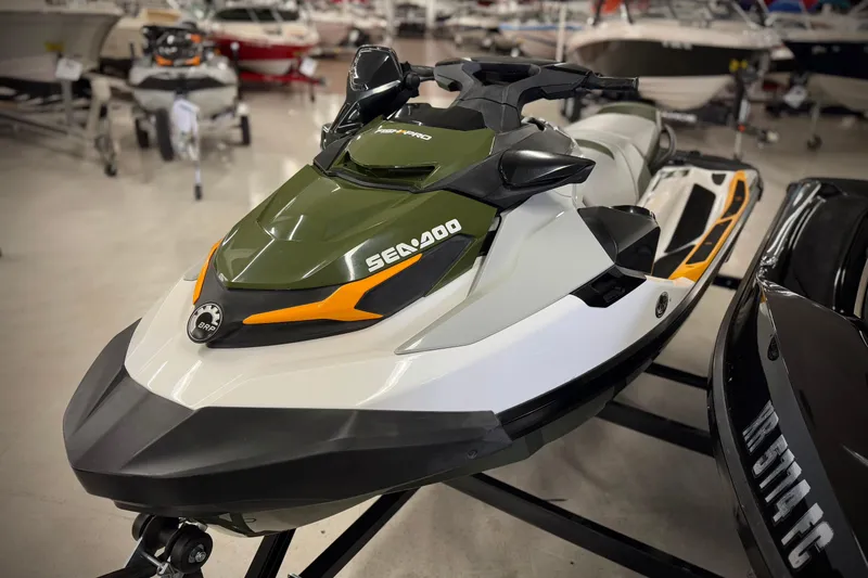 Slide: The Image of 2019 Sea-Doo Fish Pro 155 jet ski displayed in showroom, featuring sleek design and vibrant colors. - 2