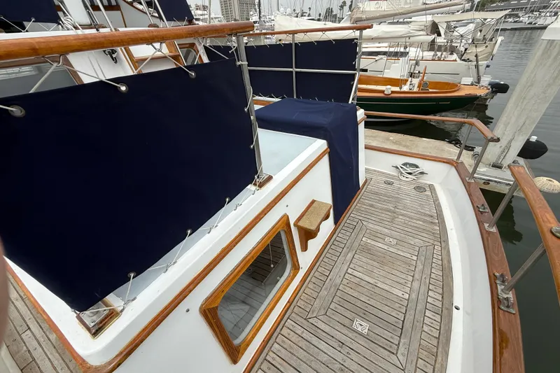 Slide: The Image of 1978 CHB 34 boat deck with wooden railings and blue canvas covers. - 10