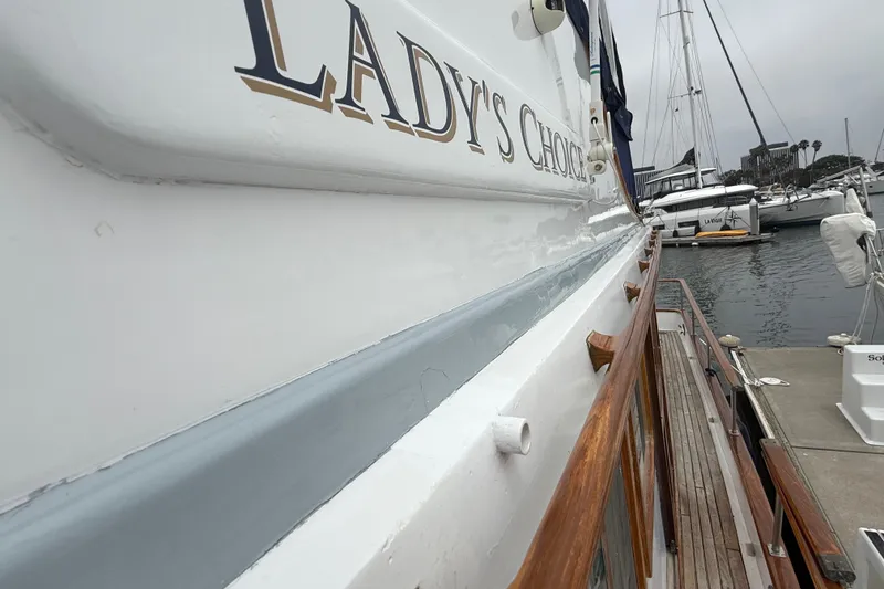 Slide: The Image of 1978 CHB 34 boat docked, featuring "Lady's Choice" name on the side. - 11