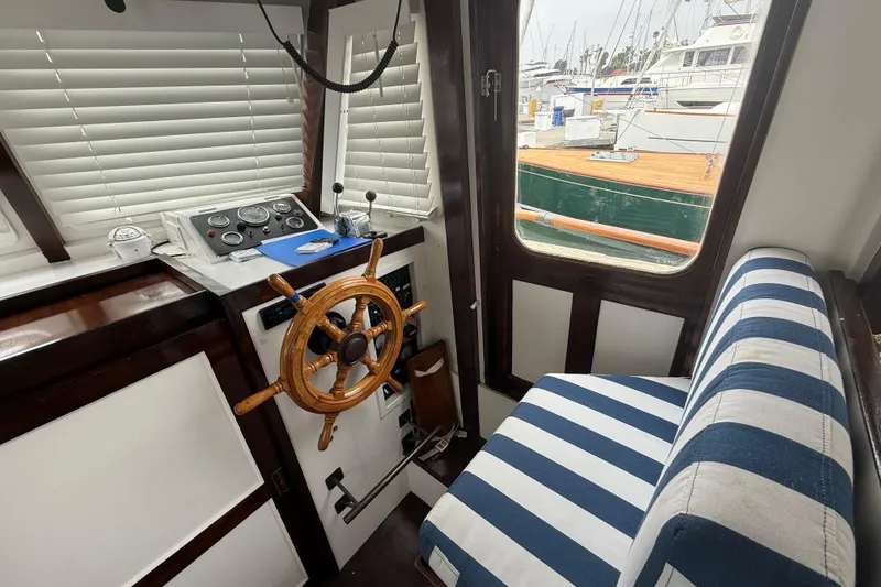 Slide: The Image of Interior of 1978 CHB 34 boat with striped seating and wooden steering wheel. - 15