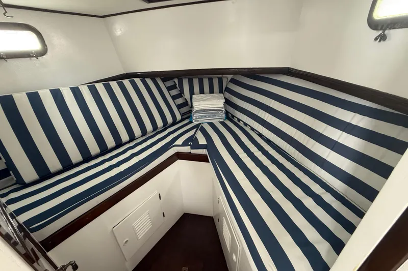 Slide: The Image of 1978 CHB 34 boat interior with striped cushions and compact cabin layout. - 18