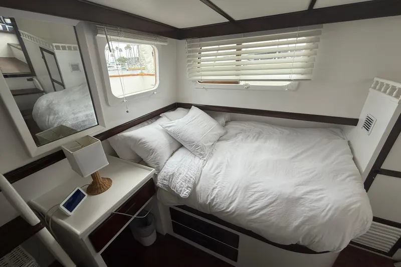 Slide: The Image of Cozy bedroom interior on a 1978 CHB 34 boat with white bedding and natural light. - 19