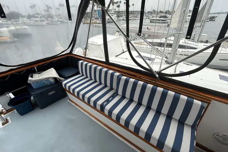 Slide: The Image of 1978 CHB 34 boat interior with striped seating and marina view. - 28