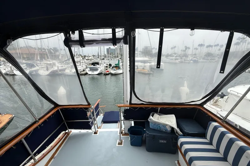 Slide: The Image of Interior view of a 1978 CHB 34 yacht overlooking a marina with docked boats. - 29