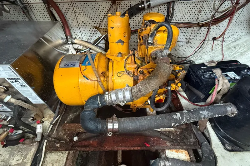 Slide: The Image of Engine room of a 1978 CHB 34 boat with yellow machinery and wiring. - 31