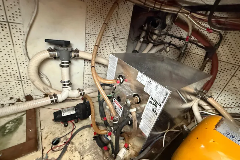 Slide: The Image of Engine room of a 1978 CHB 34 boat with plumbing and machinery. - 32