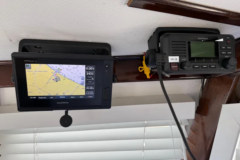 Slide: The Image of Garmin GPS and radio equipment on a 1978 CHB 34 boat dashboard. - 34