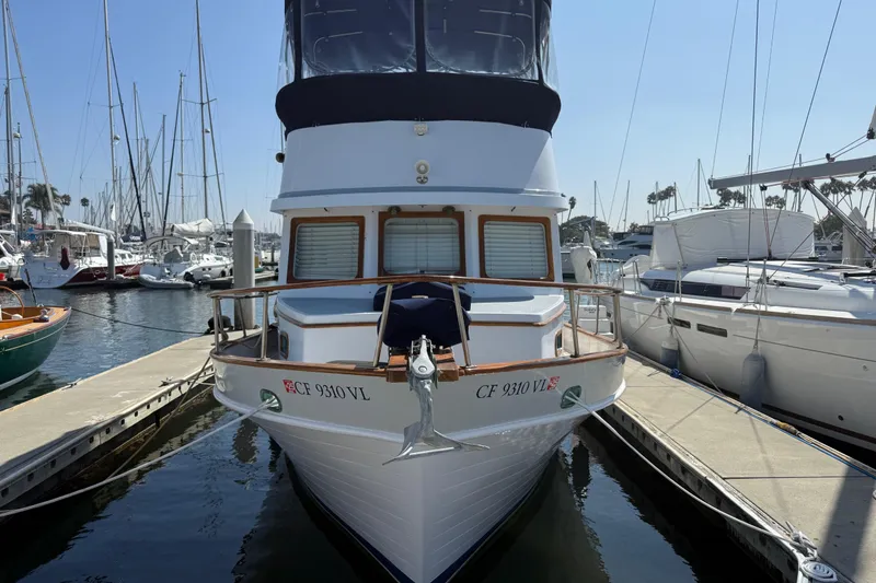 Slide: The Image of 1978 CHB 34 boat docked at marina, surrounded by sailboats under clear blue sky. - 4