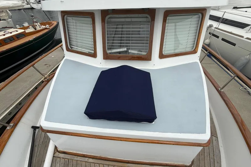 Slide: The Image of 1978 CHB 34 boat deck with windows and covered equipment at marina. - 6