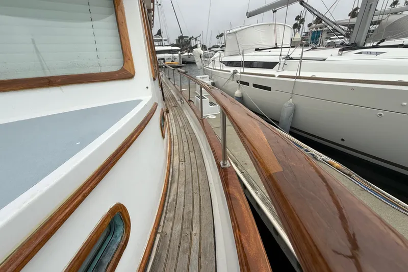 Slide: The Image of Wooden deck of a 1978 CHB 34 yacht docked beside other boats. - 8