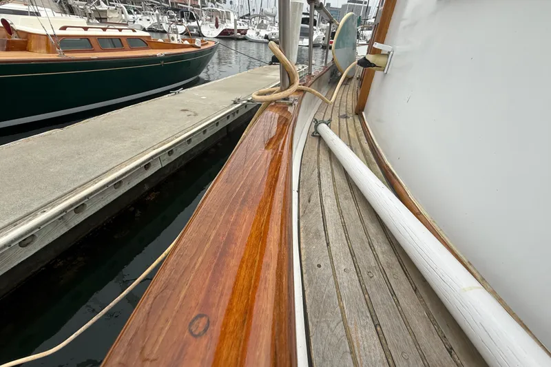 Slide: The Image of Wooden deck of a 1978 CHB 34 boat docked at a marina. - 9