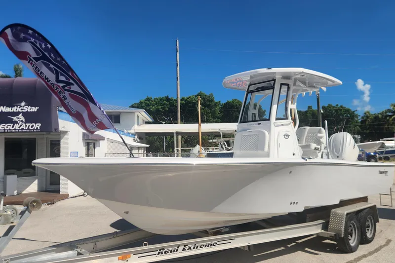 Slide: The Image of 2026 Tidewater 2500 Carolina Bay boat on trailer, displayed outdoors with clear blue sky. - 4