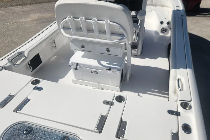 Slide: The Image of 2026 Tidewater 2500 Carolina Bay boat interior with seating and storage compartments. - 9