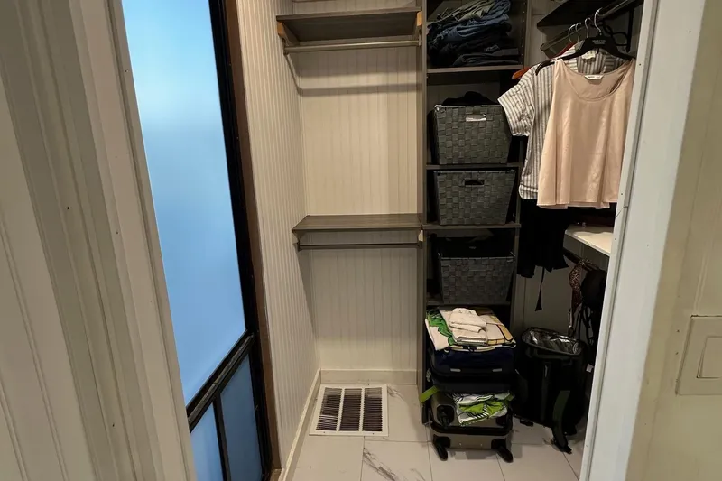 Slide: The Image of Compact closet space in a 1997 Stardust Cruisers 16x78, featuring organized shelves and clothing storage. - 13