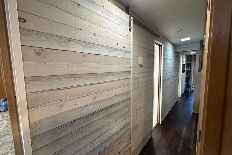 Slide: The Image of Hallway interior of 1997 Stardust Cruisers 16x78 houseboat with wooden paneling. - 15