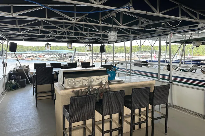 Slide: The Image of 1997 Stardust Cruisers 16x78 houseboat with outdoor bar and seating area on deck. - 18