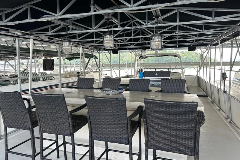 Slide: The Image of 1997 Stardust Cruisers 16x78 houseboat with outdoor dining area and grill. - 20