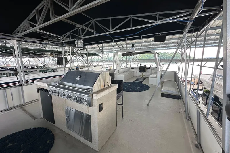 Slide: The Image of 1997 Stardust Cruisers 16x78 houseboat with outdoor kitchen and seating area on upper deck. - 21