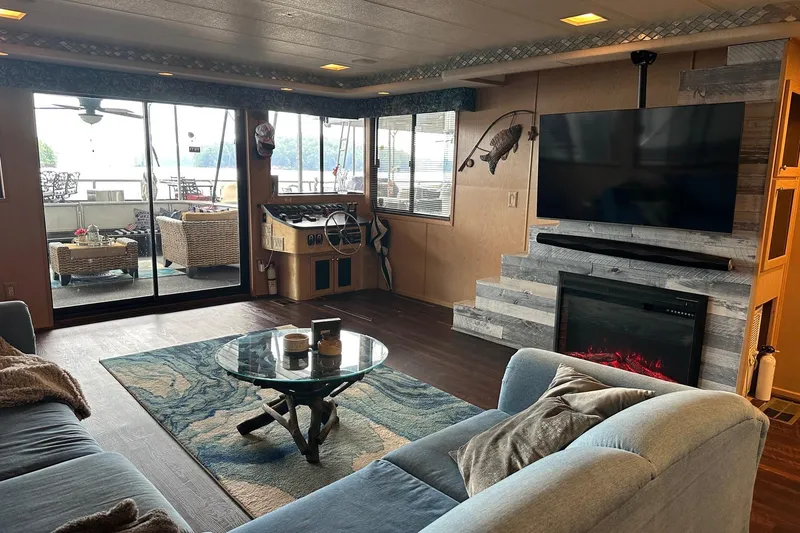 Slide: The Image of Luxurious 1997 Stardust Cruisers 16x78 houseboat interior with modern decor and cozy fireplace. - 3