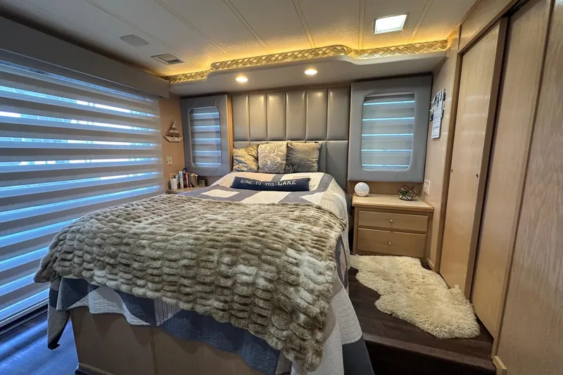 Slide: The Image of Cozy bedroom interior in a 1997 Stardust Cruisers 16x78 houseboat, featuring modern decor. - 9
