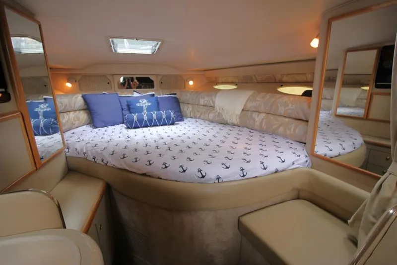 Slide: The Image of Cozy cabin interior of 1998 Sea Ray 330 Sundancer with nautical-themed bedding. - 11