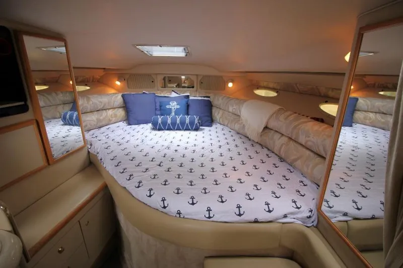 Slide: The Image of Luxurious 1998 Sea Ray 330 Sundancer cabin with nautical-themed bedding and cozy lighting. - 12