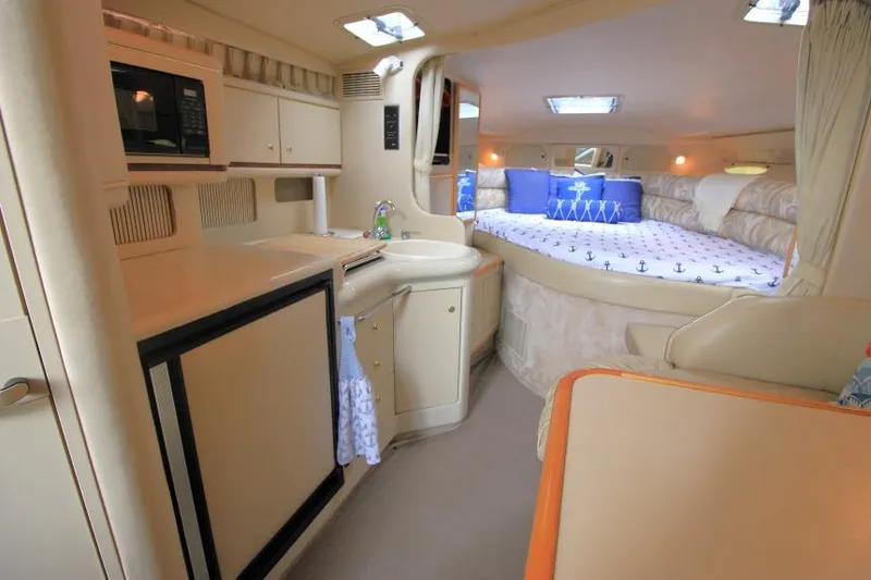 Slide: The Image of Interior of 1998 Sea Ray 330 Sundancer yacht with cozy cabin and kitchenette. - 18