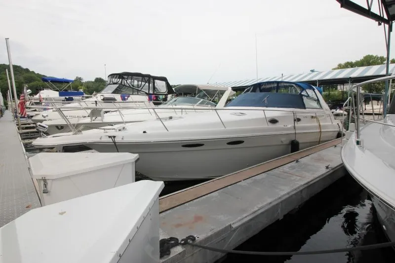 Slide: The Image of 1998 Sea Ray 330 Sundancer docked at marina with other boats. - 2