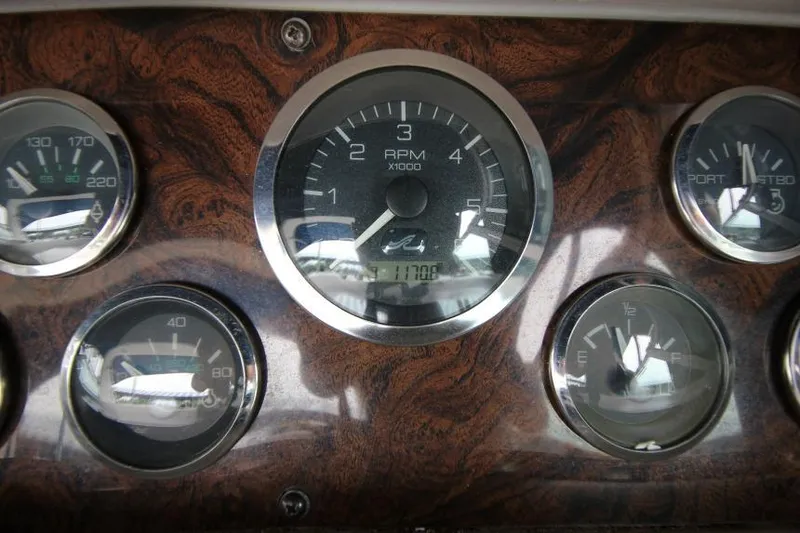 Slide: The Image of Dashboard of a 1998 Sea Ray 330 Sundancer boat with RPM and fuel gauges. - 22