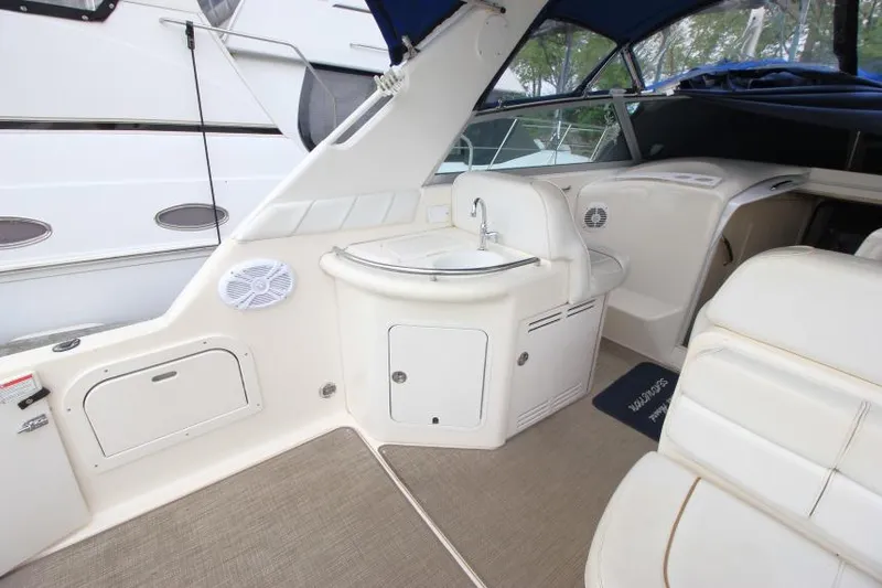 Slide: The Image of 1998 Sea Ray 330 Sundancer interior with sink, seating, and carpeted flooring. - 5