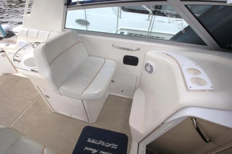 Slide: The Image of 1998 Sea Ray 330 Sundancer interior with seating, sink, and cup holders. - 8