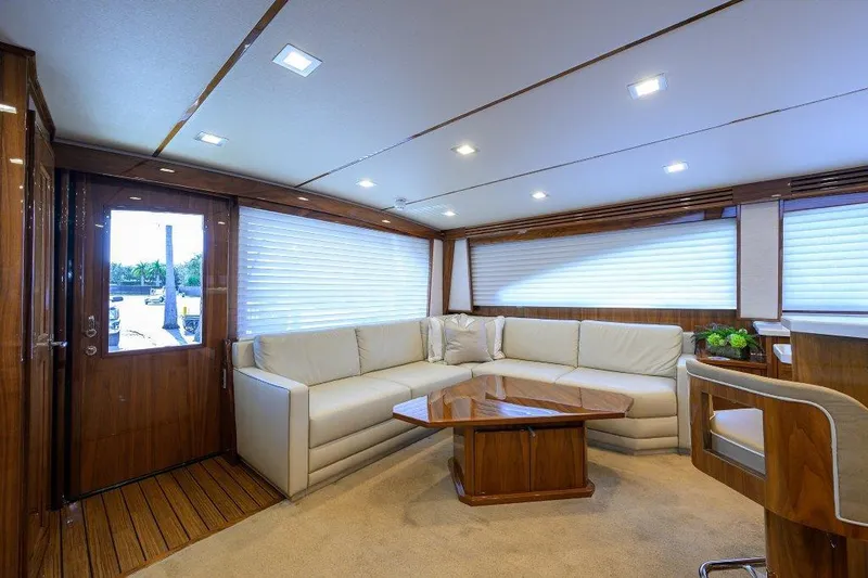 Slide: The Image of Luxurious interior of 2020 Viking 72 Convertible yacht with plush seating and wooden accents. - 10