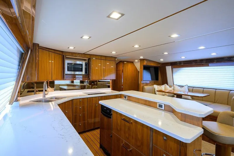 Slide: The Image of Luxurious interior of 2020 Viking 72 Convertible yacht with modern kitchen and seating area. - 17