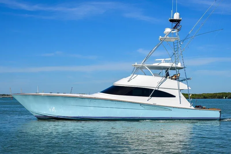 Slide: The Image of 2020 Viking 72 Convertible yacht on calm water under clear blue sky. - 2
