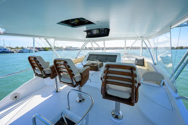 Slide: The Image of Interior view of 2020 Viking 72 Convertible yacht with helm and seating. - 42